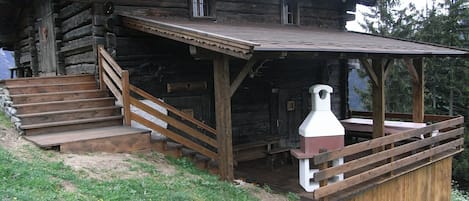 A summer photo with the covered terrace and barbecue