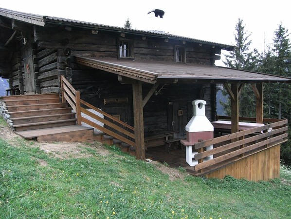 A summer photo with the covered terrace and barbecue