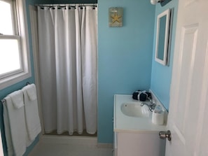 bathroom with shower and bath towels