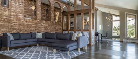 Living room with beautiful brick walls and a wood fireplace.