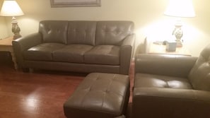 living room with new leather sofa and chairs