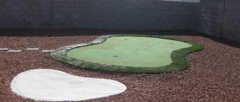 Backyard putting green with chipping area and sand trap