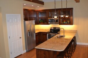 Kitchen with granite countertops and stainless appliances.