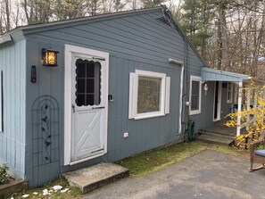 Front door and side porch deck with side entrance. 