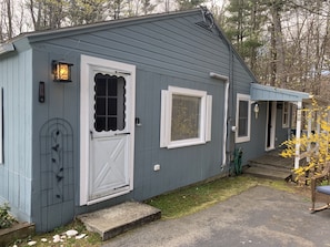 Front door and side porch deck with side entrance. 