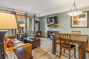 Living Room and Dining Area. A cozy gas fireplace, Queen-Size Sofabed. 