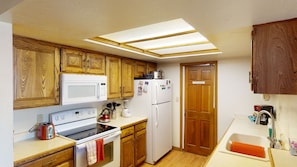 Full Kitchen with fridge, stove, oven, dishwasher, & microwave.