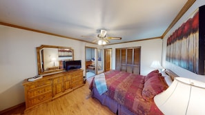 Bedroom #1 w/queen bed, dresser, TV & closet. Entrance to 3rd bedroom.