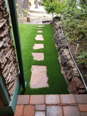 Steps from front yard to back yard .