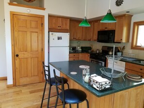 Kitchen workspace and counter. Dishwasher, microwave, plenty of cookware