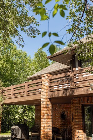 This spacious outdoor area offers a shaded patio and a sun-soaked balcony—perfect for morning coffee, grilling up dinner, or simply enjoying the peaceful forest views.