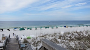 unobstructed shore line with beach chairs and umbrella 