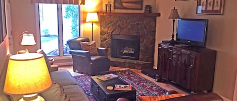 Living Room with Couch, Two Leather Arm Chairs & Gas Fireplace