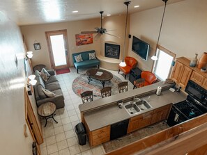 View of living room and kitchen from upstairs loft