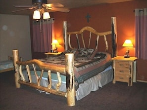 Master Bedroom Downstairs with twin bed against the wall.