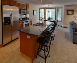 Fully-equipped kitchen with stainless appliances, granite counters and cherry 