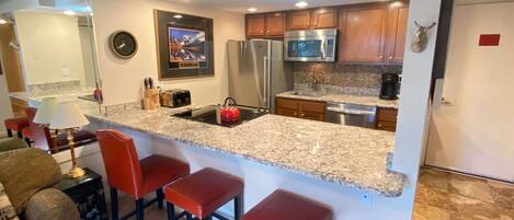 Kitchen with barstools.,