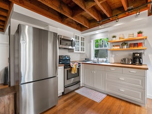 The kitchen comes stocked with full size refrigerator, freezer & electric stove.