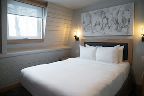 The private bedroom features a luxurious queen bed.