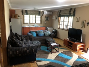 Open plan lounge and kitchen leading onto the deck 