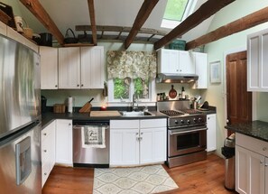 Farmhouse style kitchen with commercial DCS gas range.