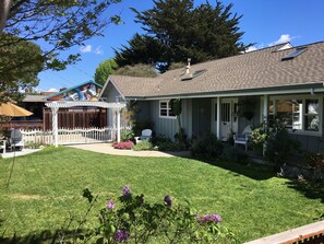 Manicured front yard with seating areas