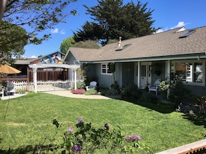 Manicured front yard with seating areas