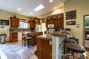 Kitchen is spacious and has bar seating.