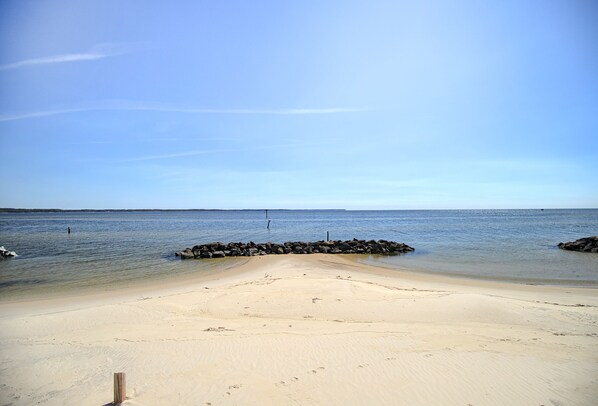 Sandy Beach 50 ft from the house. Perfect H2O with a large sandbar for swimming.