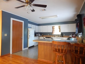 Full kitchen upstairs with table for 4 and large bar 