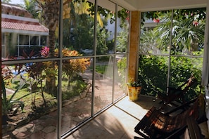 The Screened Downstairs Porch Has Seating for Close Up Pool and Garden Viewing