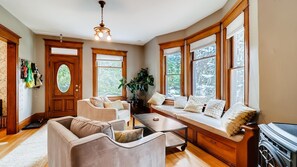 Front living room with fireplace and large windows