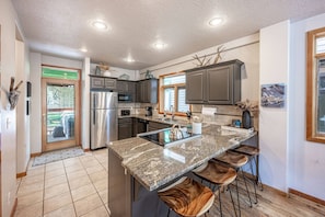 The home has a spacious, fully stocked and updated kitchen with granite countertops, hardwood cabinetry and stainless steel appliances.