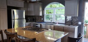 New remodeled kitchen with farm sink and gas stove top