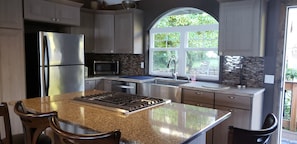 New remodeled kitchen with farm sink and gas stove top