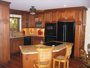 Kitchen with Cherry Wood Cabinets and Granite Counters