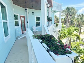 Front entry with comfy seating overlooking professionally landscaped property