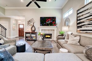Living room view to front entry and stairs.