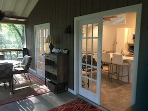 French doors open to the screened porch from living room kitchen and bedroom 