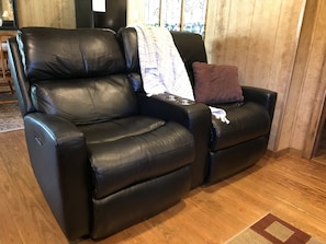 Relax in power leather love seats.  Charging stations included!