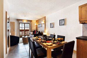 Sit down at the dining table and enjoy a tasty meal.