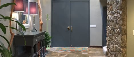 Entry way with live trees and skylights.