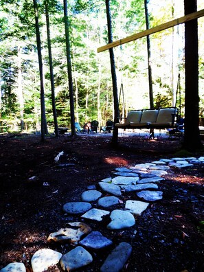 Swing seating and stone walkway.