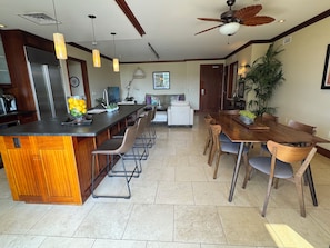 Open floor plan with new chairs in the kitchen, dining and living rooms.