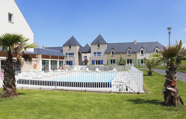 You will love to dive into the pristine outdoor pool on a hot summer day.