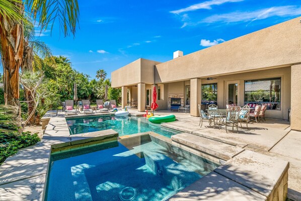 Backyard:  Pool and Spa with Sheet Water Fall feature, Covered Patio Sectional Sofa, Two Dining Tables, Outdoor Fire Place, Pool Loungers and BBQ with Bar.