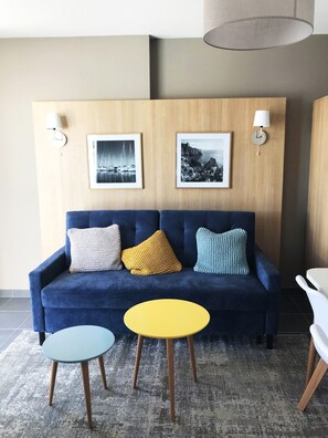 The living area is bright and cozy, perfect for relaxing after a day on the beach.