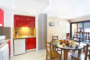 Prepare meals in the kitchenette and enjoy them at the dining table.