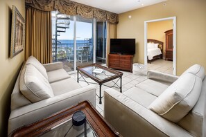 Living room with TV and private balcony with water views
