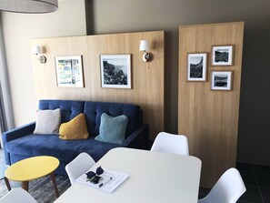You will love to hang out in the air-conditioned living area, complete with a sofa and a dining table.